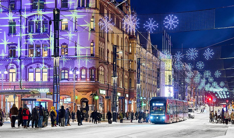 A Christmassy picture from Hämeenkatu: a tram, people, Christmas lights and snow. 